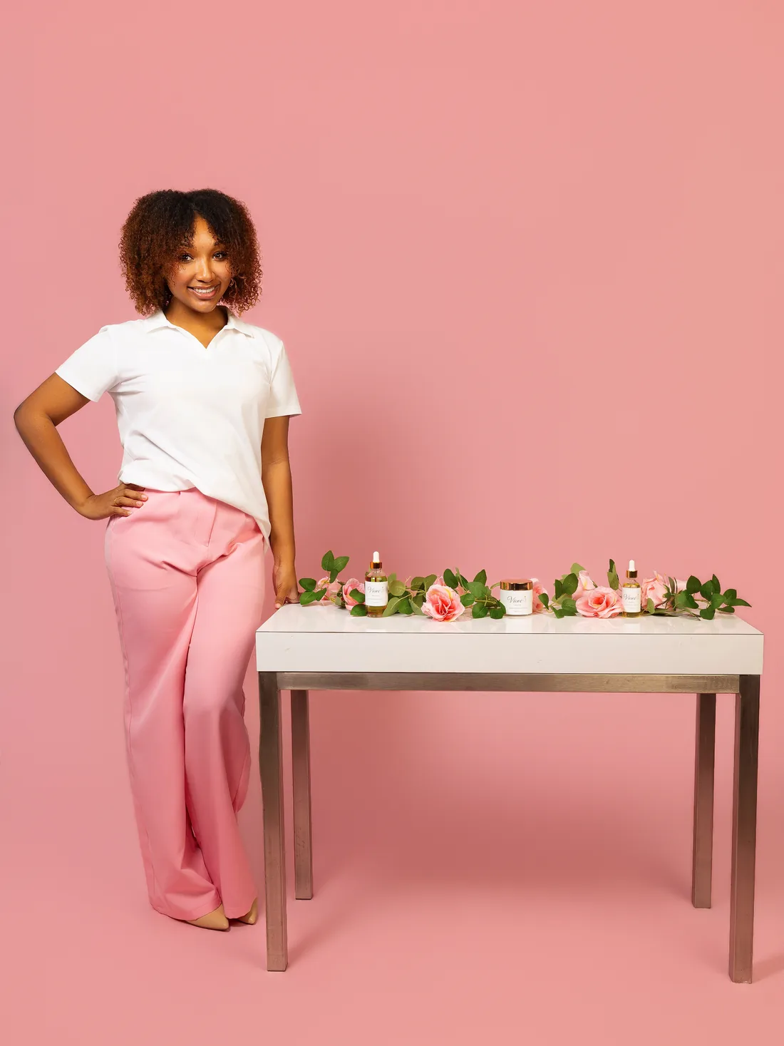 The founder of Vioré standing beside a table styled with the collection